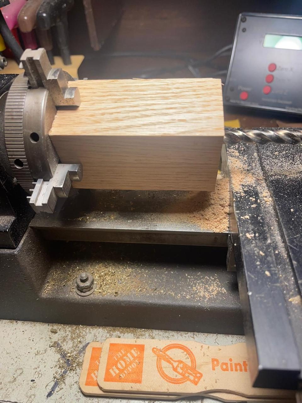 Jerry hand-turning a custom wooden clock component on a lathe